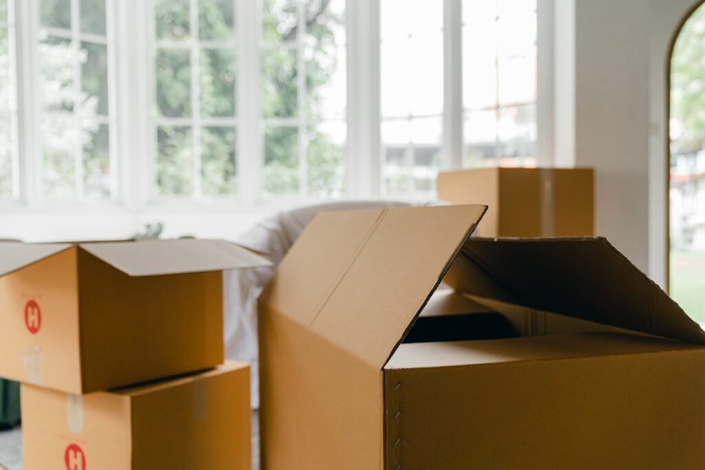 Open cardboard boxes during a house move. Illustrating the mortgage industry outlook for 2023