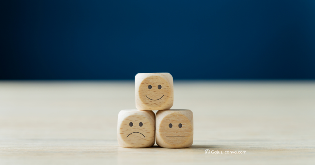 Dice with happy, sad, and indifferent faces. By Gajus, canva.com