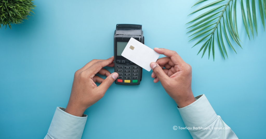 A credit card being tapped on a card machine.