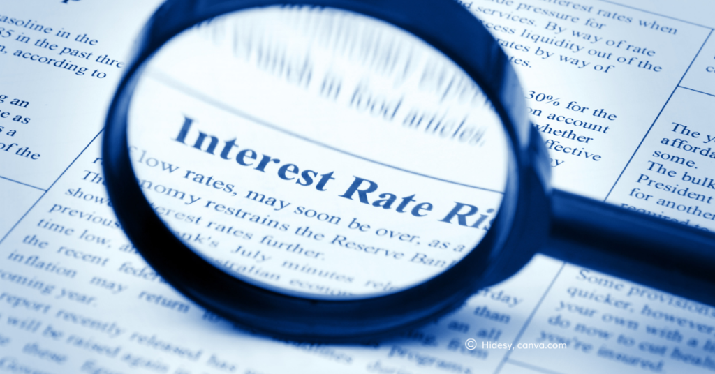 Magnifying glass over the words "interest rates", by hidesy, canva.com