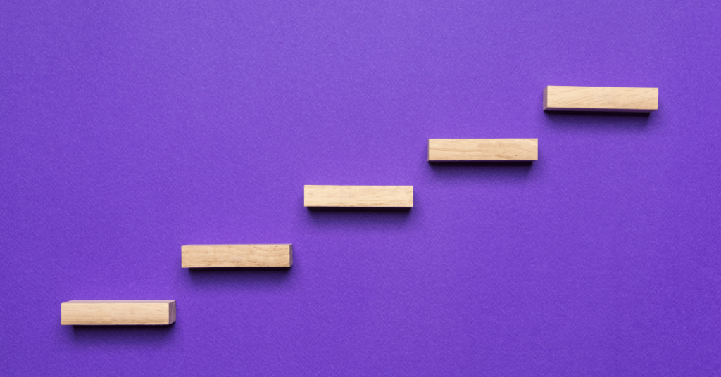 10 Steps to Success - blocks placed as steps on a purple background