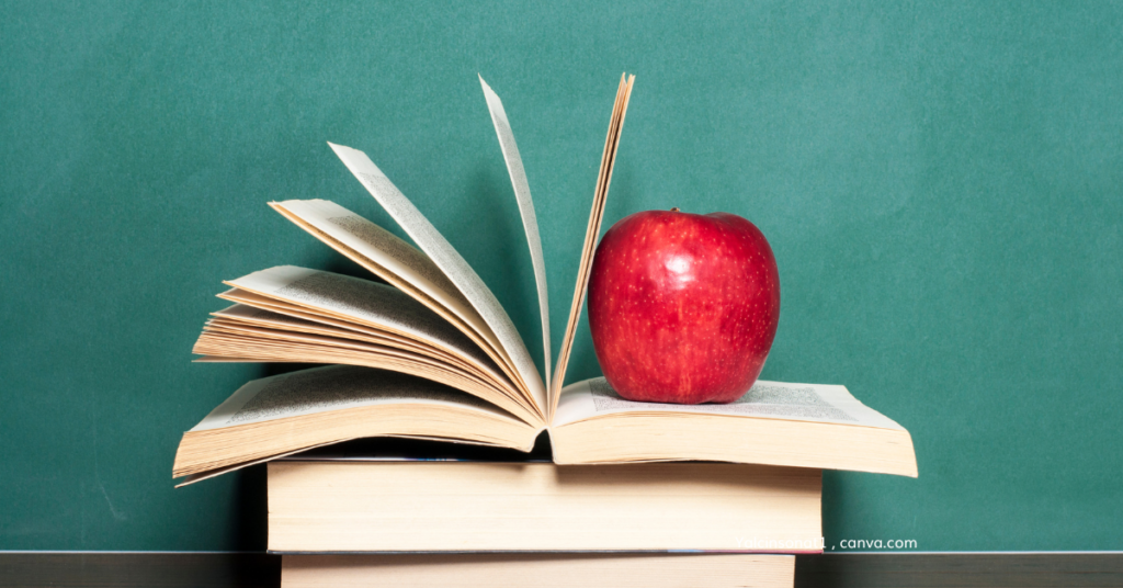 Books with a red apple on top, by yalcinsonat1, canva.com