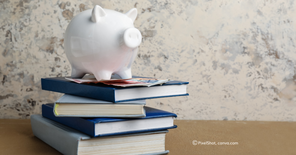 A piggybank stands on a pile of books, by PixelShot, Canva.com